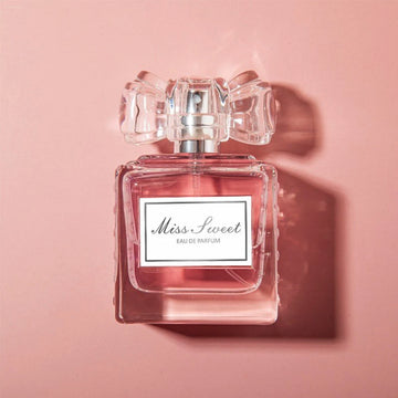 Long-Lasting Perfume for Women in a clear bottle with a ribbon design, featuring sweet floral notes.